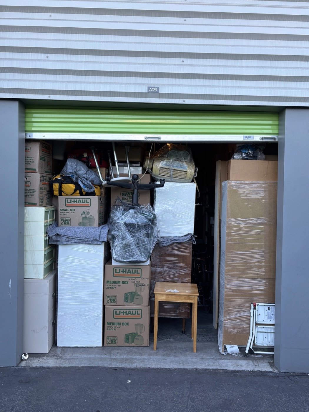 Wrapped furniture and boxes organized in a storage unit on an EasyWay project.